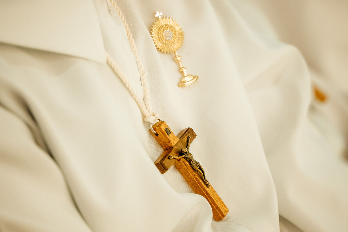 Detail of alb, cincture and pectoral crucifix
