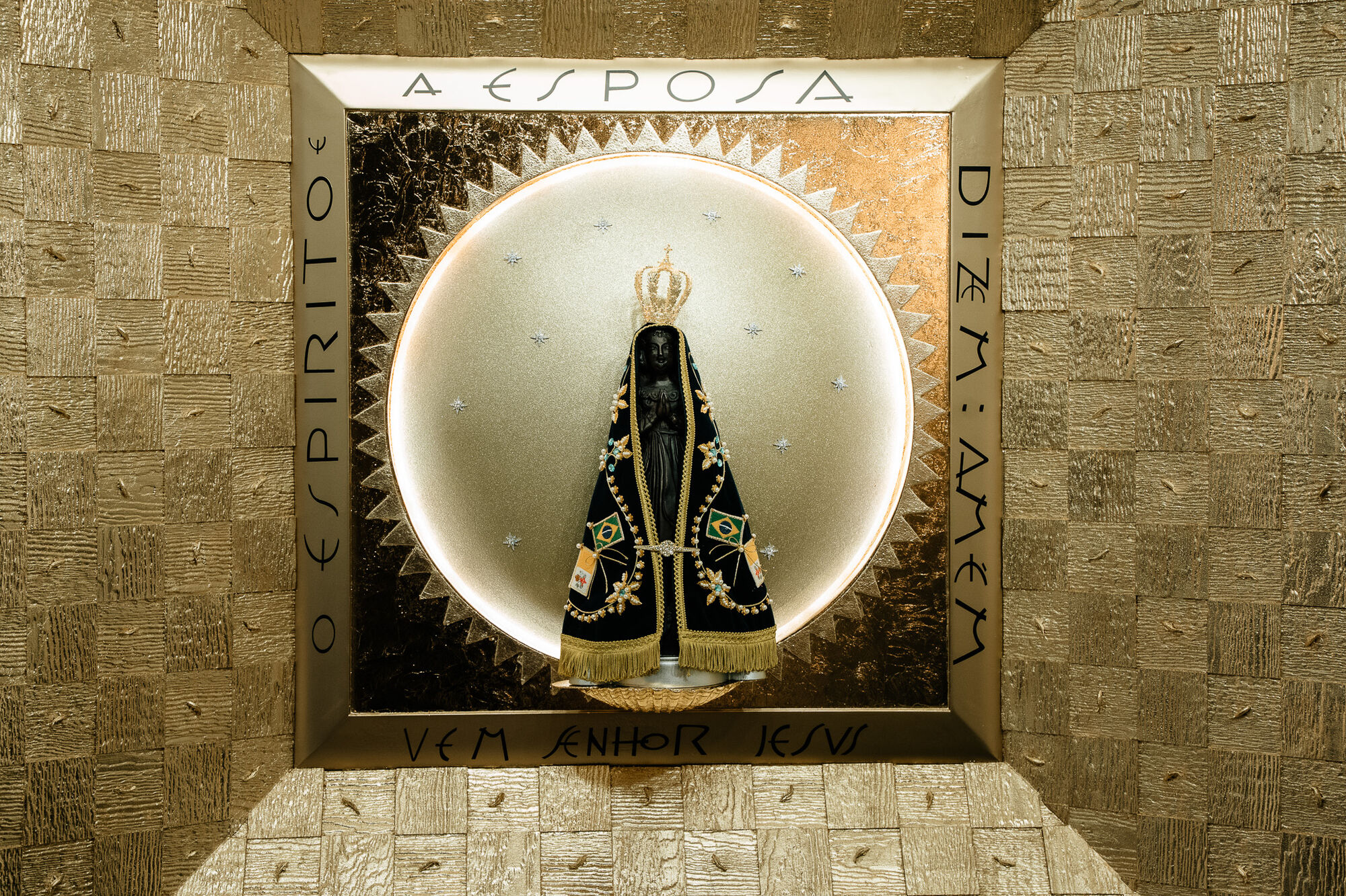 The bronze statue of Nossa Senhora Aparecida set in a gilded shrine niche inscribed 'The Spirit and the Bride say: Come, Lord Jesus'