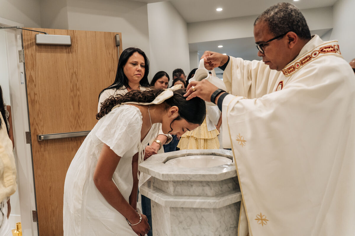 A young woman receives the sacrament of Baptism at Our Lady of Aparecida