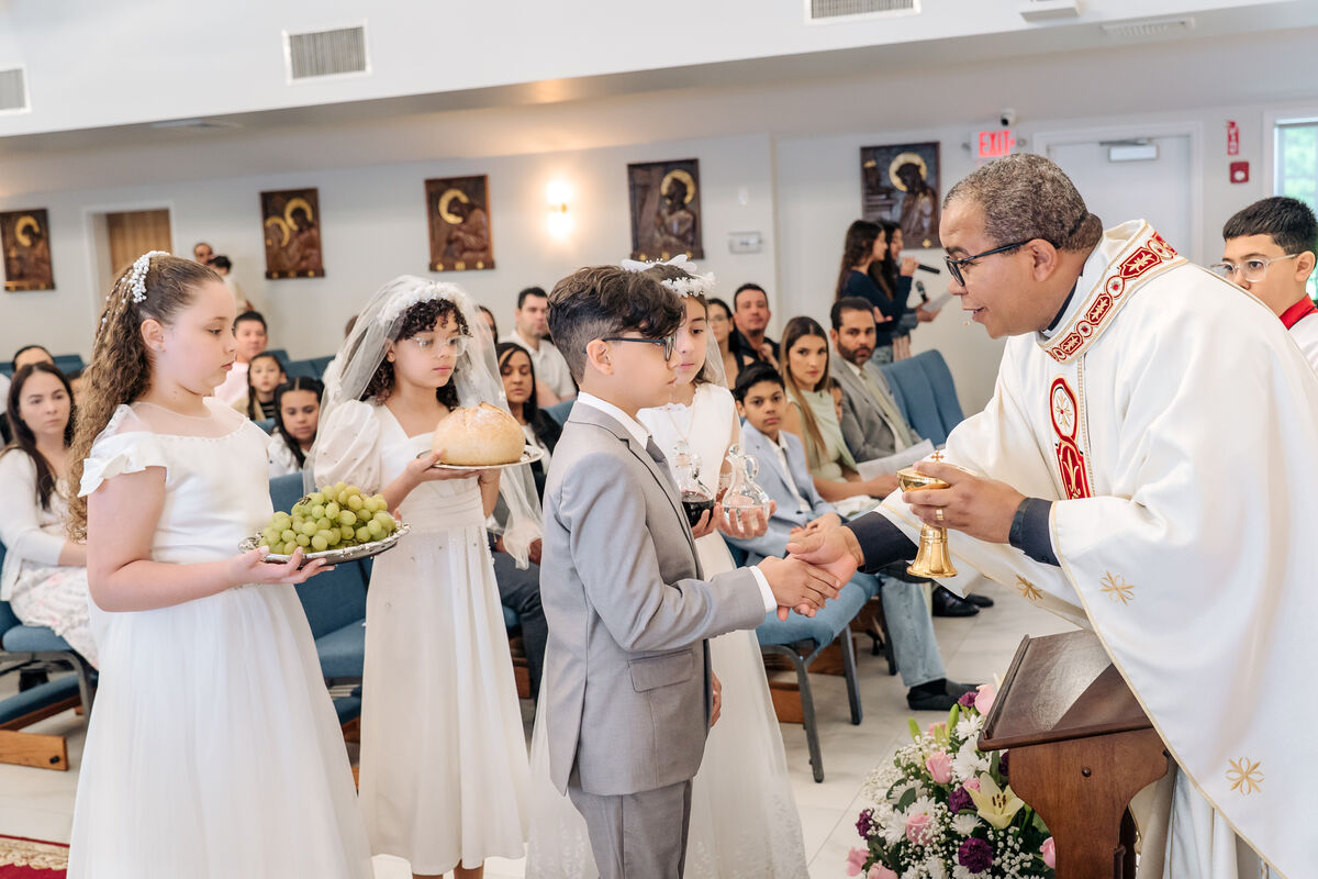 Children bring the offertory at First Communion