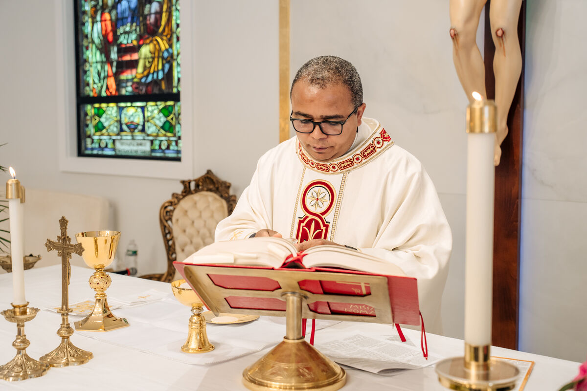 Priest reads from the Roman Missal