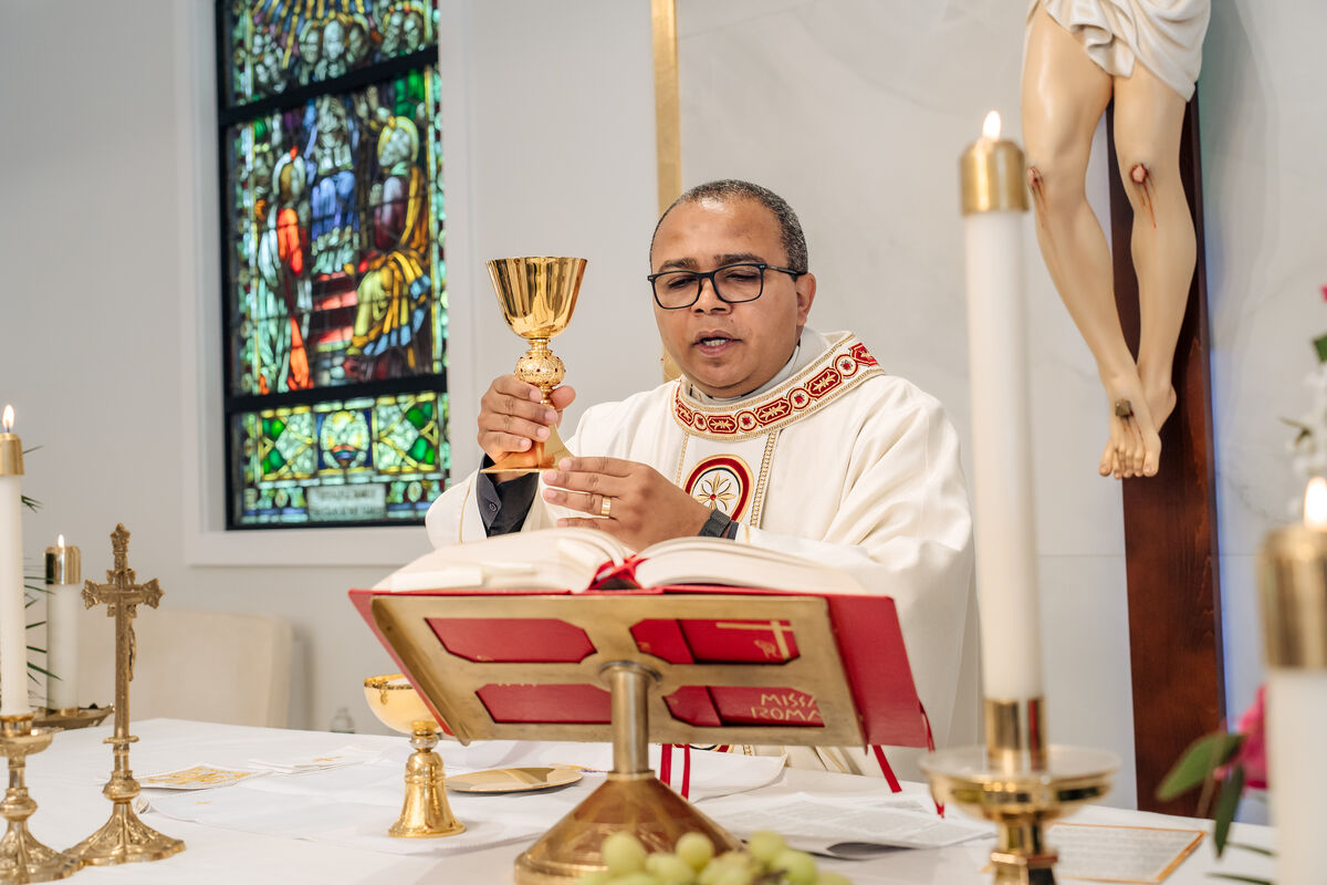 The priest elevates the chalice at the consecration during Mass at Our Lady of Aparecida