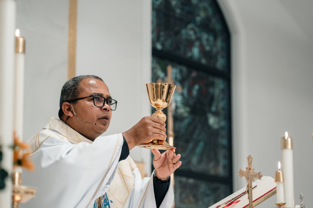 Priest elevates the chalice during Mass