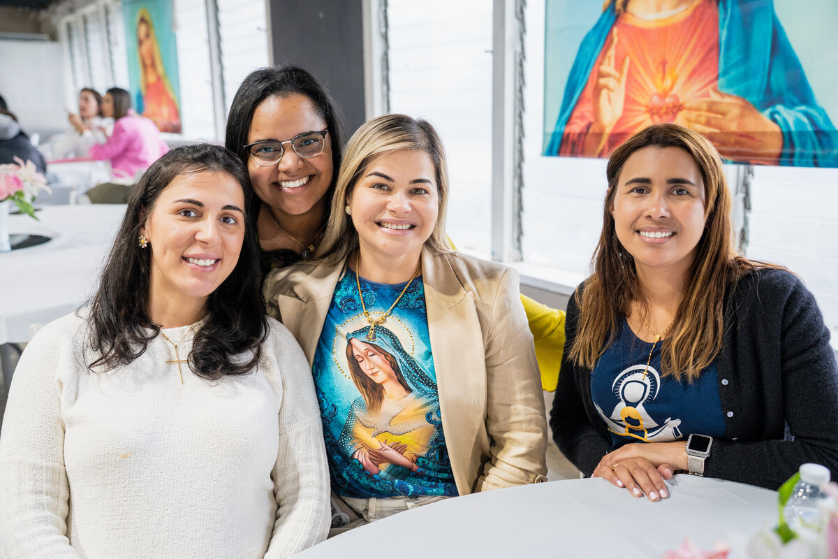 Parishioners smiling together at the Women's Conference at Our Lady of Aparecida